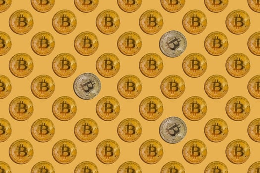 Seamless pattern of virtual money bitcoin with silver splashes on yellow background photo
