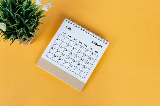 August 2023 desk calendar on yellow background. Directly above. Flat lay. photo