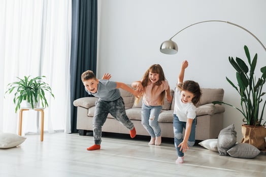 Kids having fun in the domestic room at daytime together photo