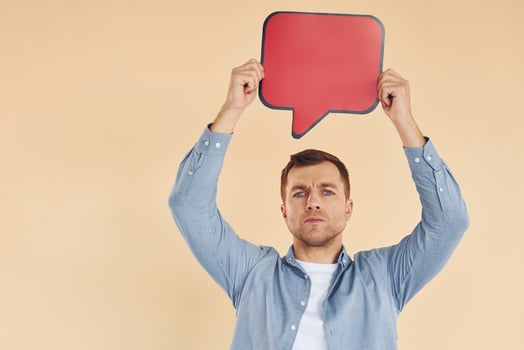 Facial expression. Man standing in the studio with empty signs for the text photo