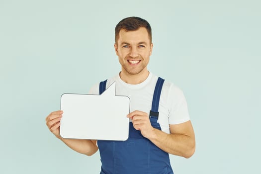 Worker saying something. Man standing in the studio with empty signs for the text photo
