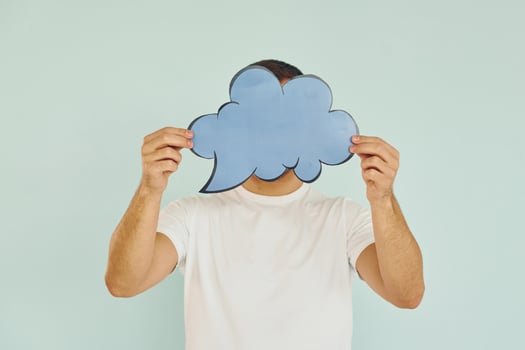 Cloud looking signs. Man standing in the studio photo