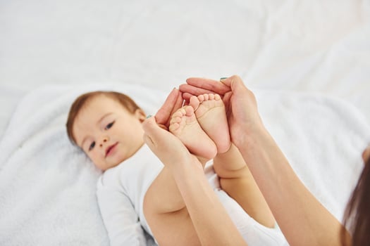 Playing around. Mother with her little daughter is indoors at home together photo