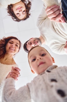 View from below. Happy family looking down and having fun photo