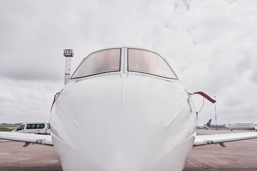 Front view. Turboprop aircraft parked on the runway at daytime photo