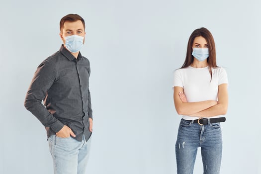 Man and woman standing indoors in the studio against white background photo