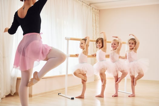 Practicing pose. Little ballerinas preparing for performance photo