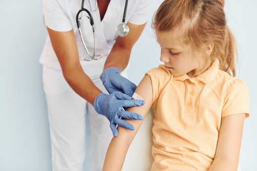Professional occupation. Doctor in uniform making vaccination to the patient photo