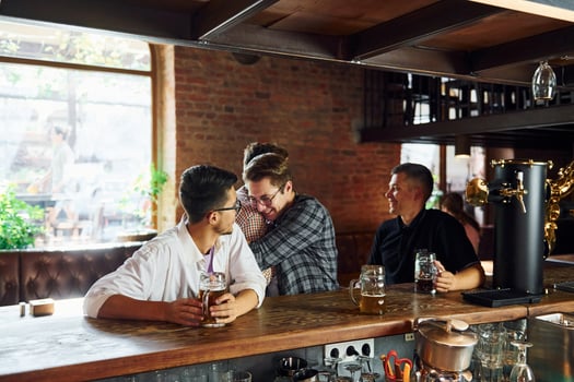 At daytime. People in casual clothes sitting in the pub photo