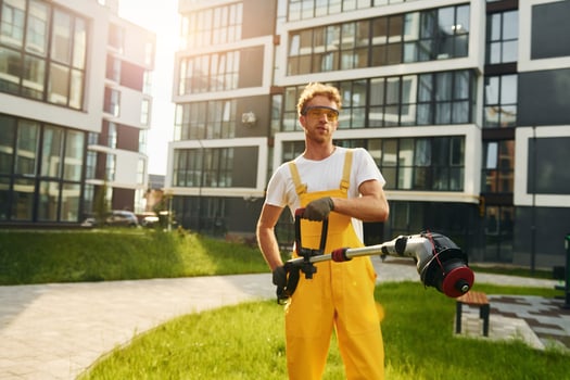 Man cut the grass with lawn mover outdoors in the yard photo