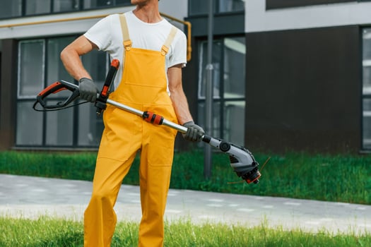 Outdoors in the yard. Man cut the grass with lawn mover photo