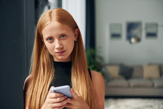 Female teenager with blonde hair is at home at daytime photo