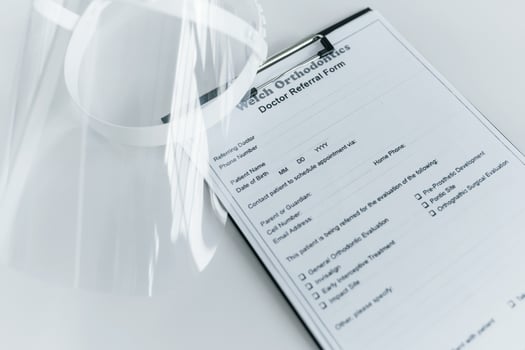 Close up view of protective mask and medical agreement that is on the white table photo