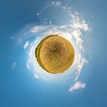 Little planet transformation of spherical panorama 360 degrees. Spherical abstract aerial view in field in nice evening with awesome beautiful clouds. Curvature of space. photo