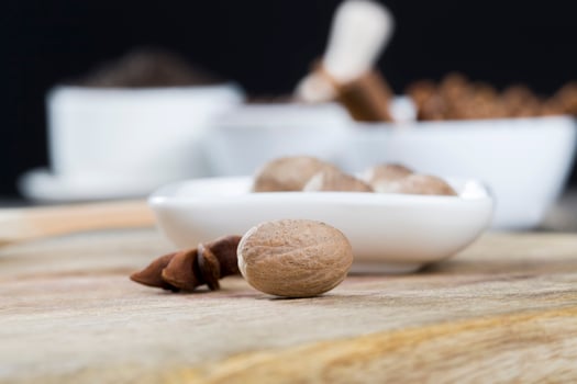 nutmeg scattered on an old wooden table photo