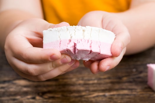 a beautiful red haired boy with delicious sliced sweets photo