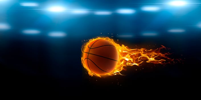 asketball on fire in basketball court stadium with lights in the field shining photo