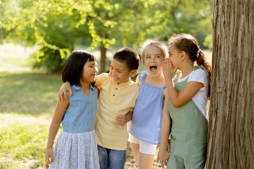 Group of asian and caucasian kids having fun in the park photo