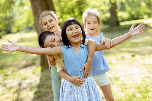 Group of asian and caucasian kids having fun in the park photo