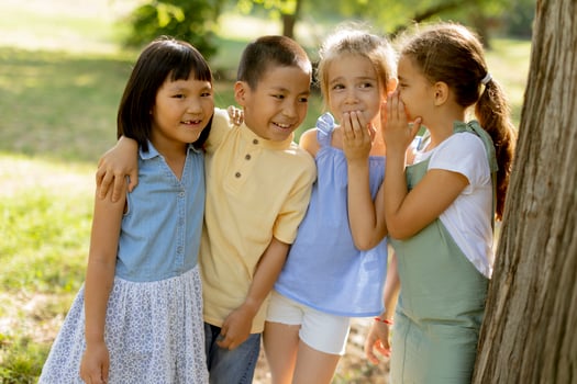 Group of asian and caucasian kids having fun in the park photo