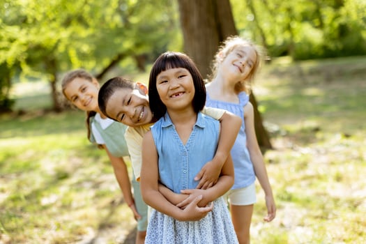 Group of asian and caucasian kids having fun in the park photo