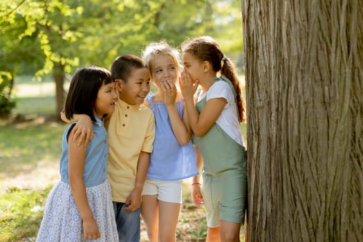 Group of asian and caucasian kids having fun in the park photo