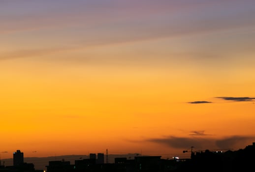 Gives a warm feeling,sunset behind the city building,silhouette city tall buildings,building silhouette again beautiful sky background and freedom concept. photo