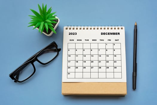 December 2023 desk calendar on blue background. Directly above. Flat lay. photo