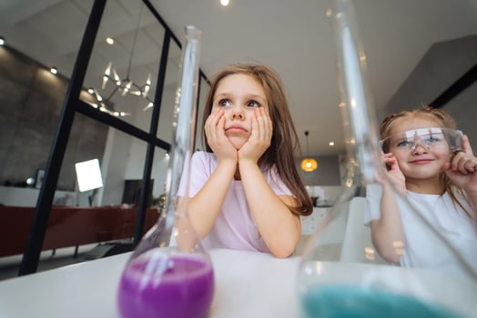 Little girls making chemical experiments at home photo