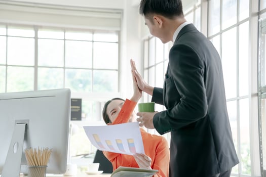 Happy asian business team working together in office photo