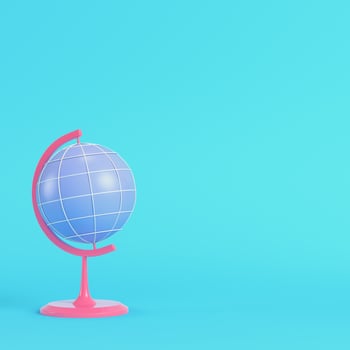 Pink chool globe on bright blue background in pastel colors photo
