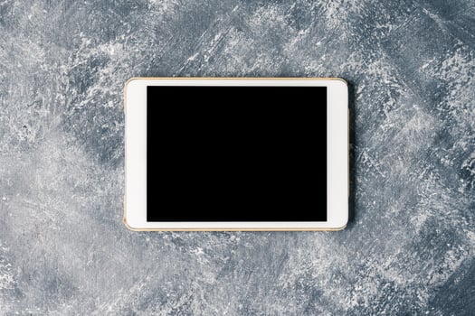 White tablet touch computer gadget with touch blank black screen on grunge background. photo