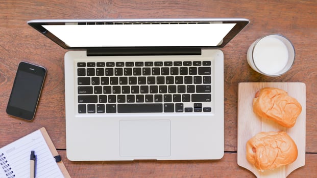 Labtop,notebook,mobile phone and breakfast on wooden table photo