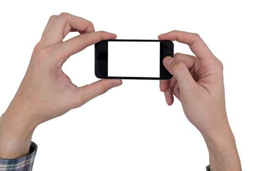 Male hands holding a mobile phone with touch blank white screen on white background. photo