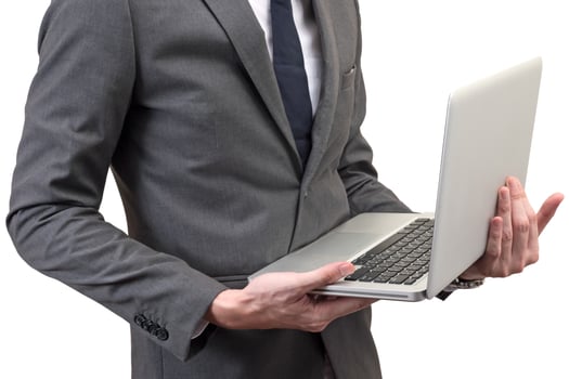 Businessman holding laptop isolated on white background. photo