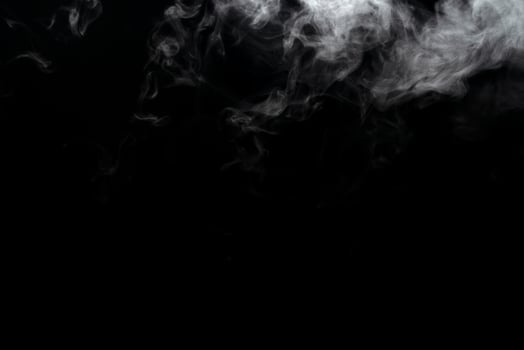 Abstract powder or smoke effect isolated on black background photo