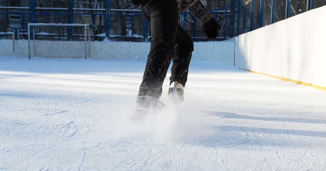 Adult Men's Ice Skates close-up on Ice in Winter outdoor on the move. Rolling and sliding in frosty sunny day, active winter sports and lifestyle photo