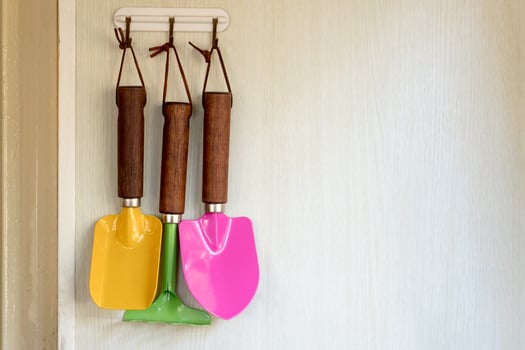 Gardener colored tools hold on wall photo