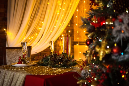 Christmas interior of the dark living room of the house. Christmas tree, lights of garlands on the walls, library Cabinet, books on the shelves. Luxury interior. New Year, red and gold balls. photo