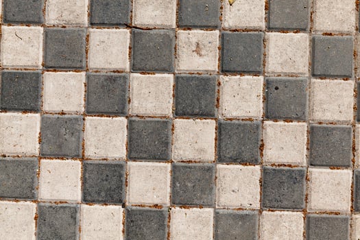 road is made of black and white concrete tiles photo