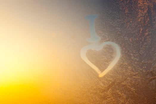 a heart painted on a frozen window photo