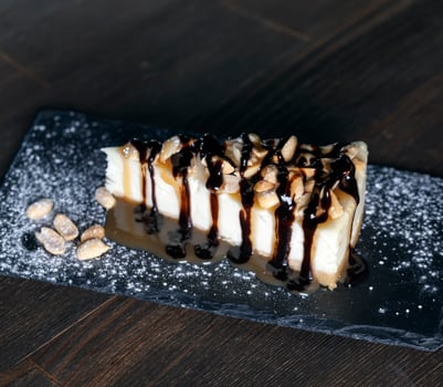 dessert cheesecake covered with caramel and chocolate photo
