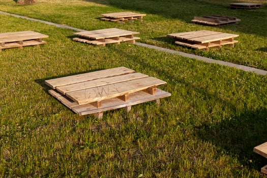 wooden pallets on the grass, close up photo