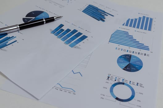 Business documents chart and graph finance statistic with pen.Paperwork report diagram investment and analysis information accounting marketing plan concept. photo