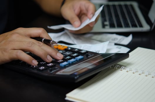 Man hand holding pen and calculator bills or tax receipt. business finance concept. photo