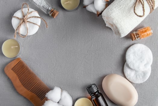Spa accessories and cosmetics on gray texture background. Towel, soap, hairbrush, essential oil. photo