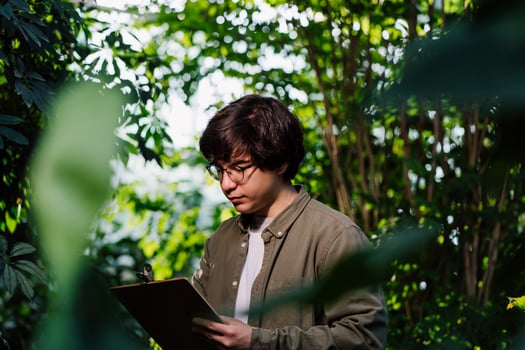 Nature protection and wildlife preservation concept. Male scientist carefully studies his data photo