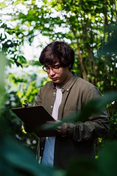 Nature protection and wildlife preservation concept. Male scientist carefully studies his data photo