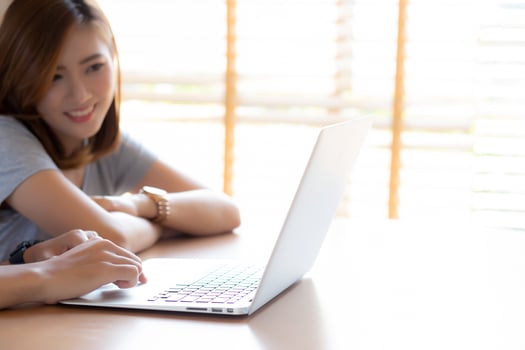 Asian young couple using laptop computer think and searching internet together, man and woman casual smiling work at home with happy and relax, communication and business concept. photo
