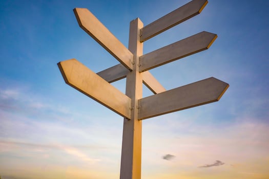 Wooden Guide Post on Sunset Sky background photo
